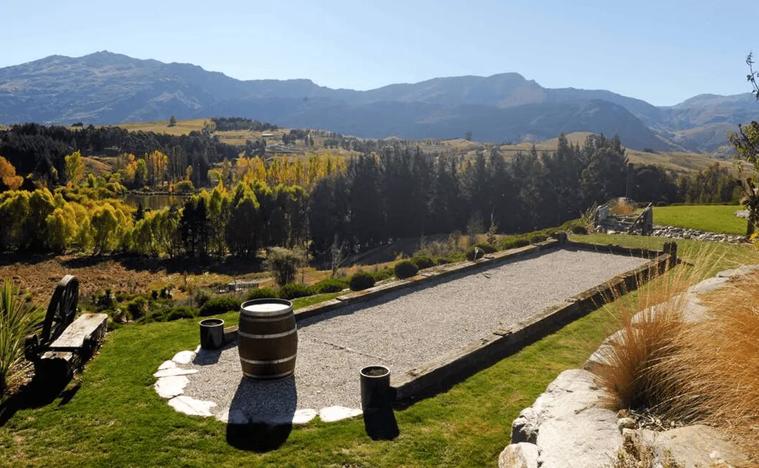 HawkRidge Chateu, Queenstown | Pétanque court edging using rustic recycled hardwood sleepers & chunky rustic beam from the old Nelson wharf