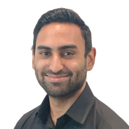 Smiling man with dark hair and beard wearing a black collared shirt.