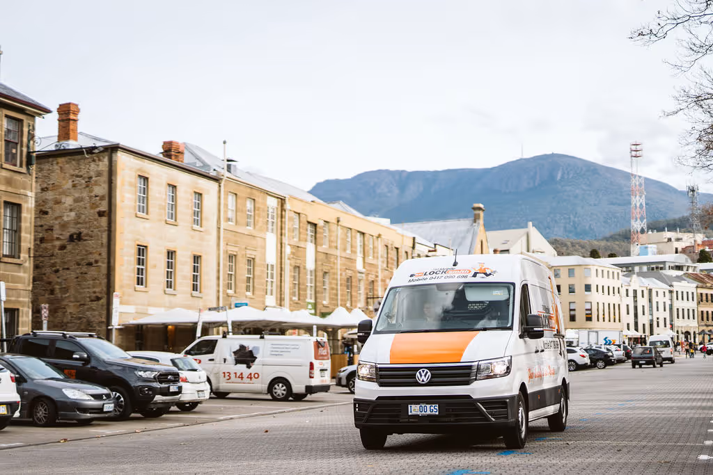 One of our locksmithing vans driving down a main street in Hobart.