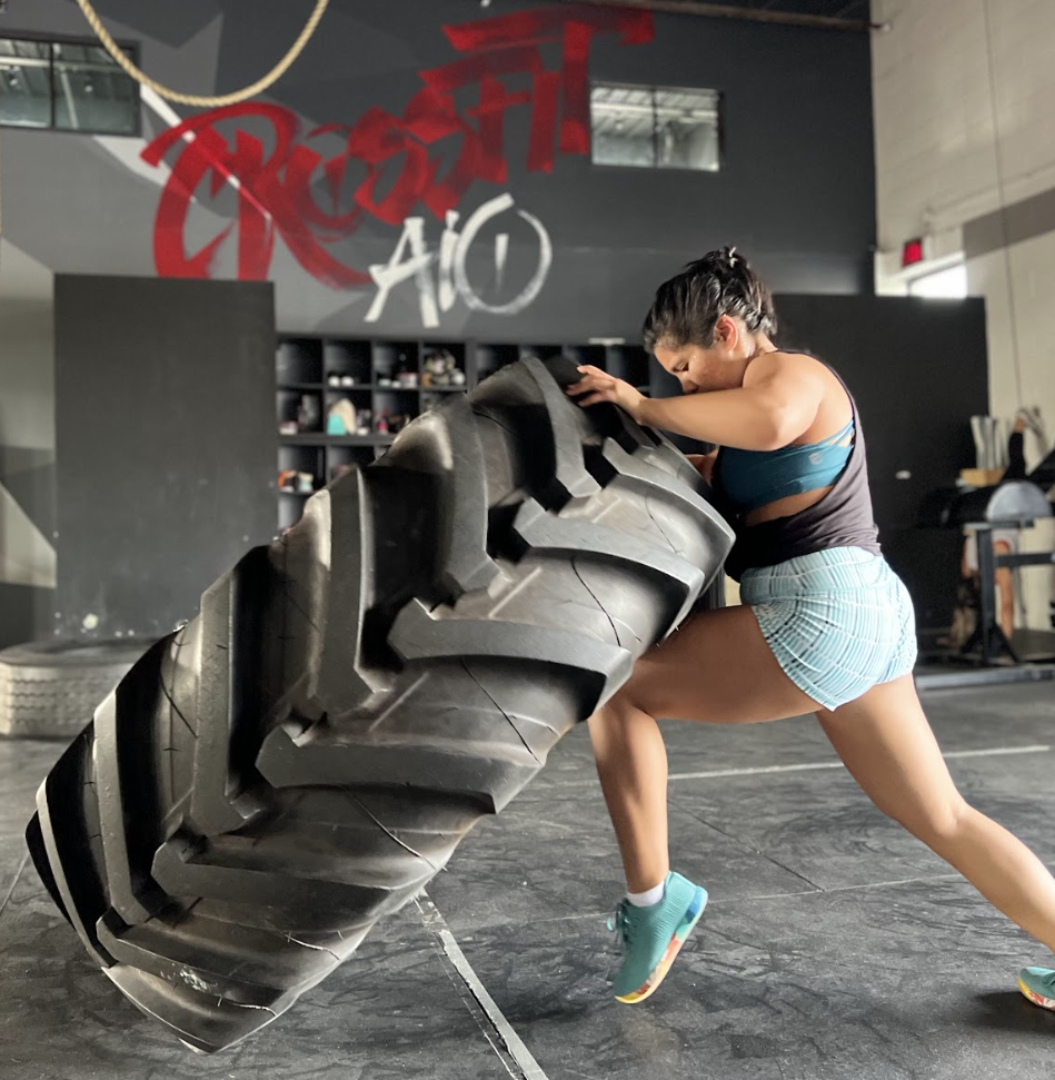 Strong woman doing a tire filp