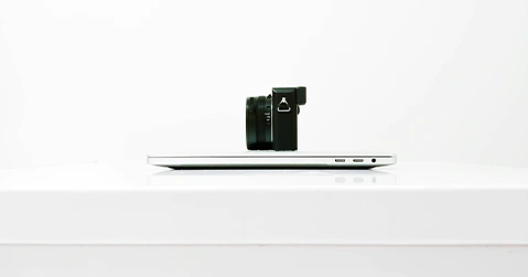 Small black object placed on white tabletop.