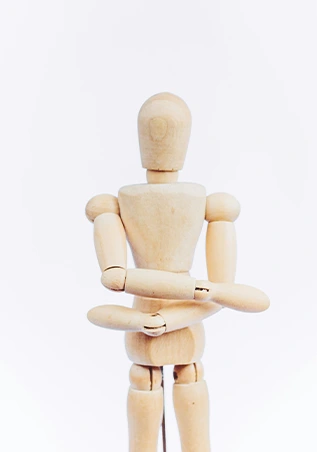 Wooden artist mannequin in upright pose.