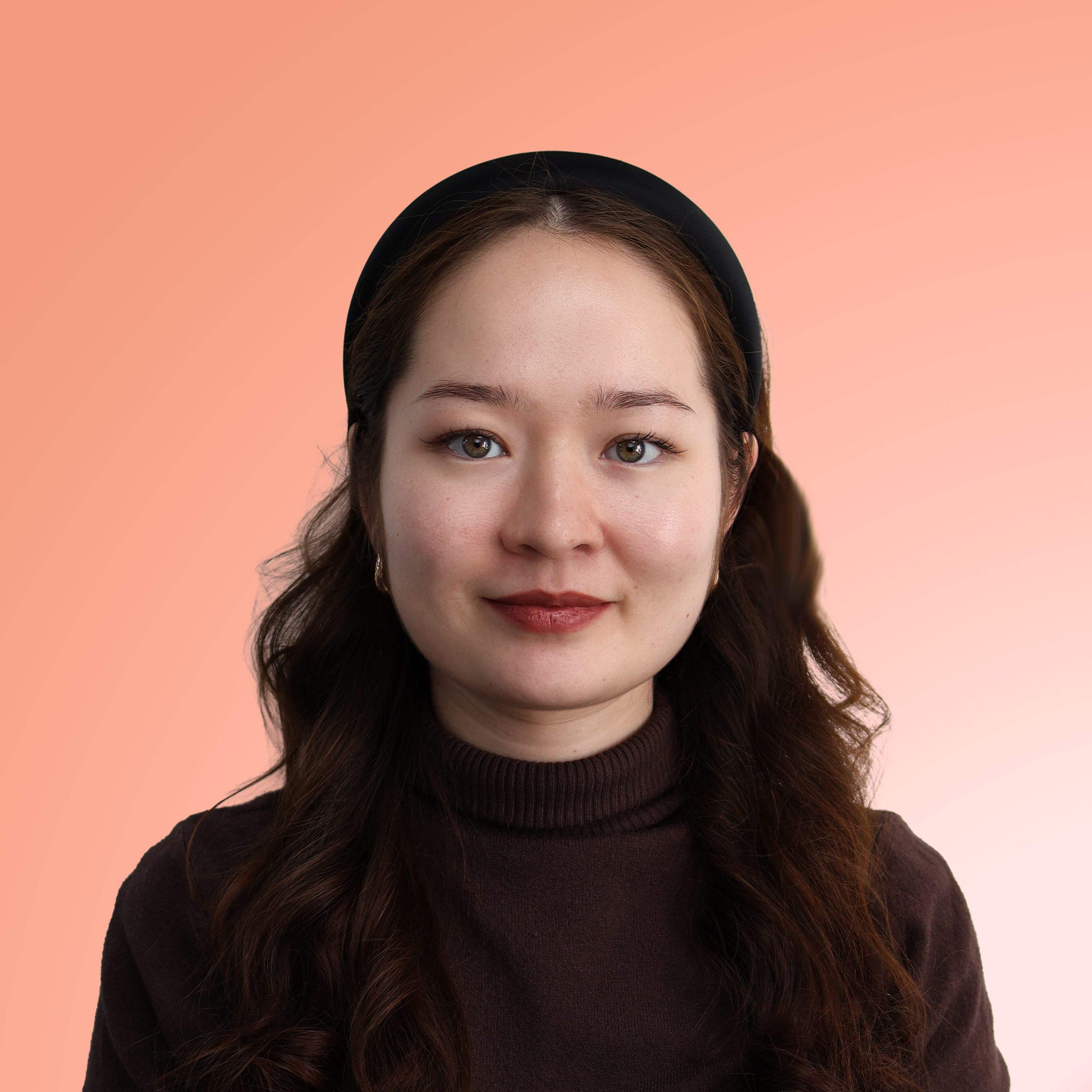 Portrait of a woman with long wavy brown hair wearing a black headband and a dark brown turtleneck sweater against a peach gradient background.
