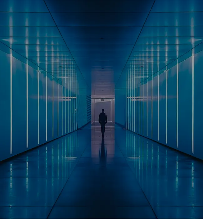 Man walking in blue lighted passage