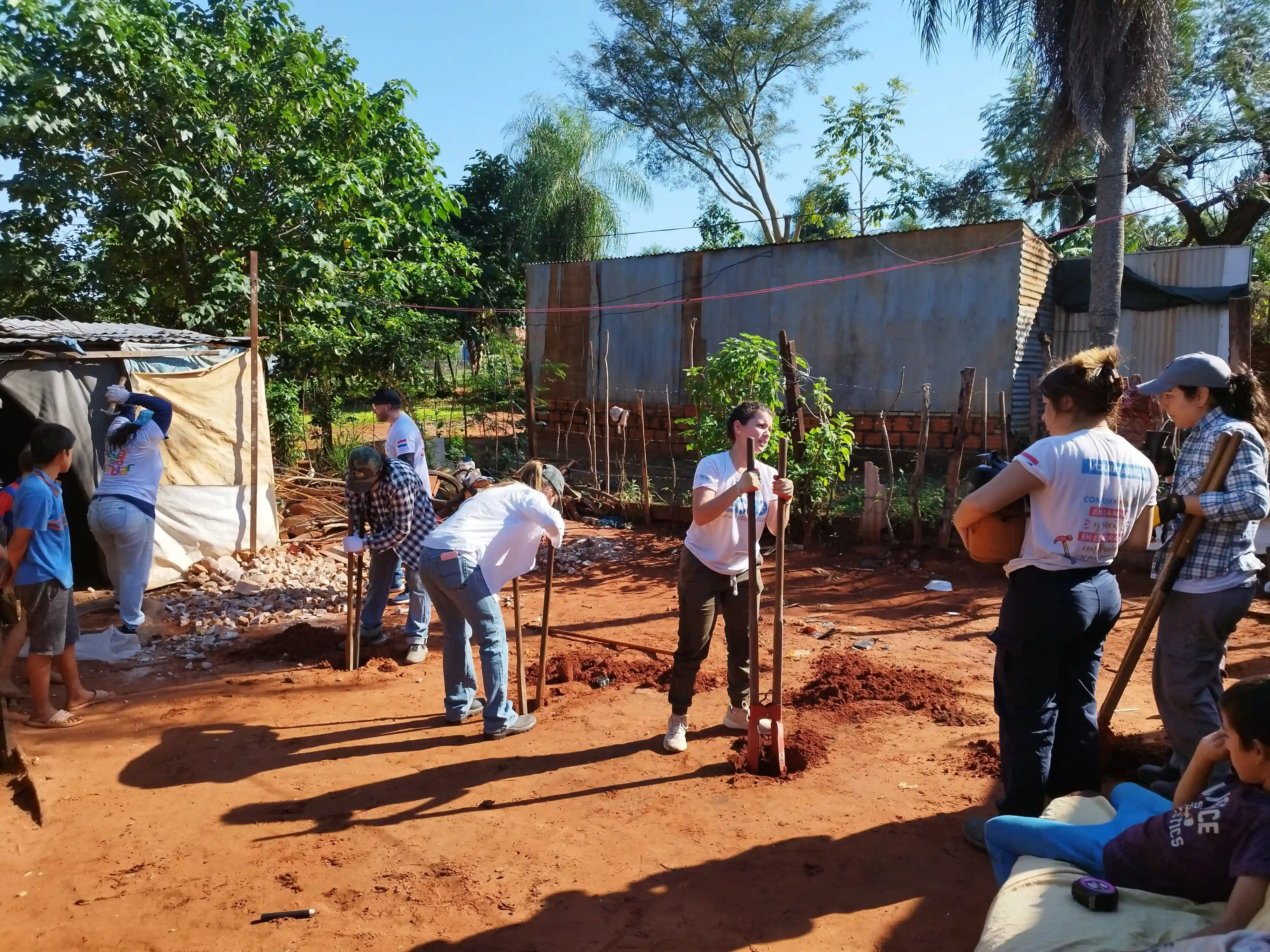 Volunteers work outdoors digging and planting, reflecting Deriv’s commitment to sustainability, conservation, and a greener future.
