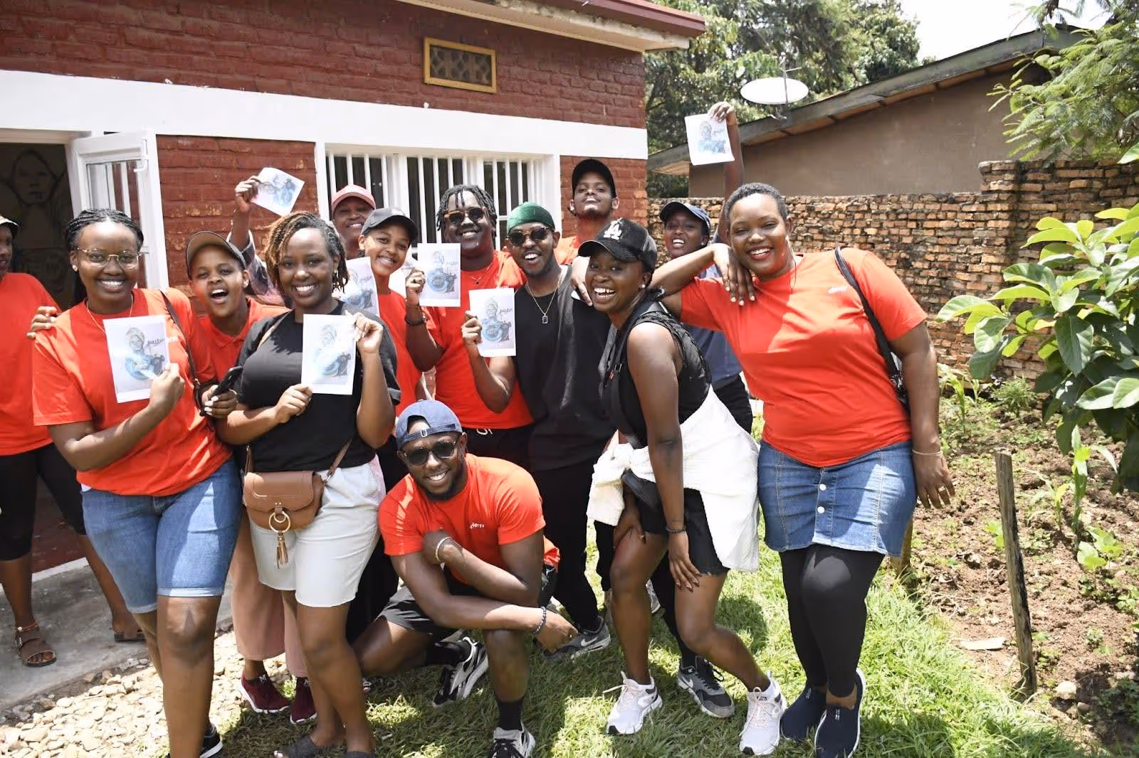 Deriv Rwanda employees posing with their planned workshop painting