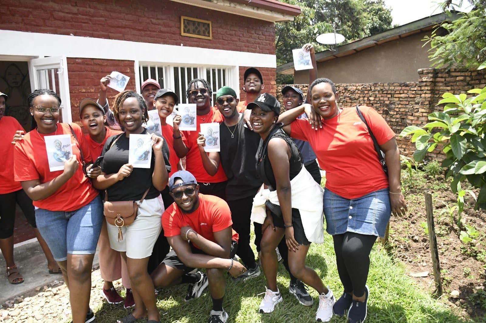 Deriv Rwanda employees posing with their planned workshop painting
