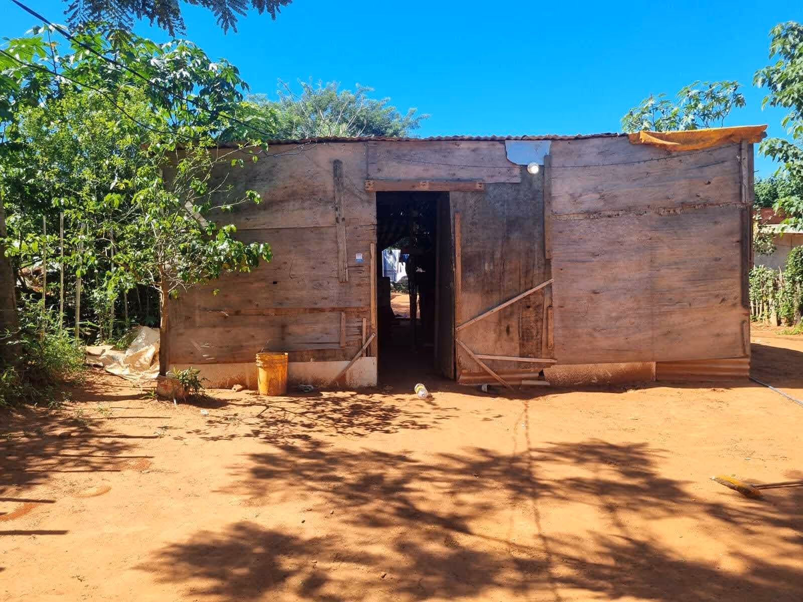 A house made of plywood and tarpaulin.