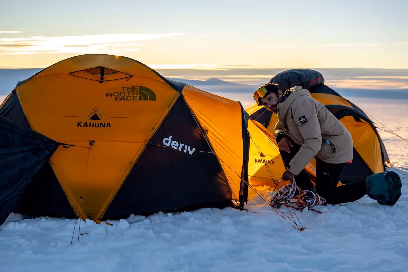 An explorer setting up the pulkas on the infinite glacier.