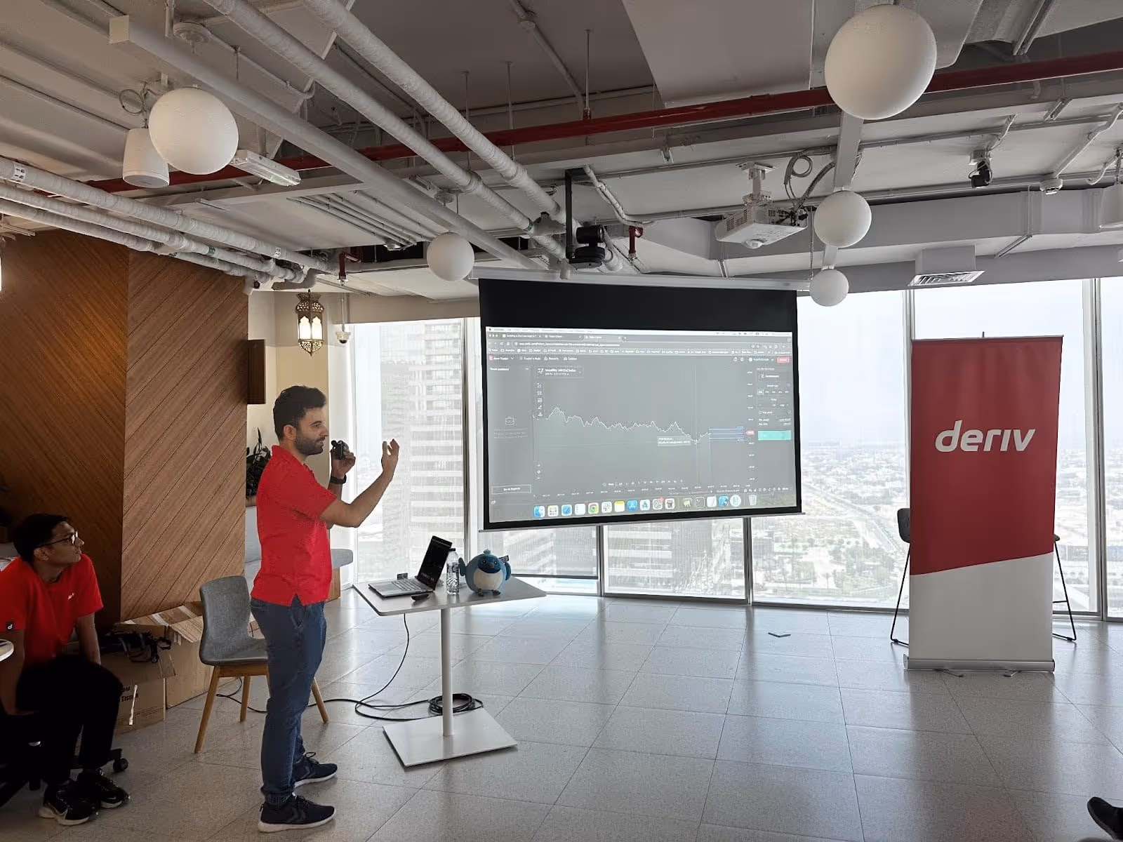 A Deriv mobile app expert giving a presentation.