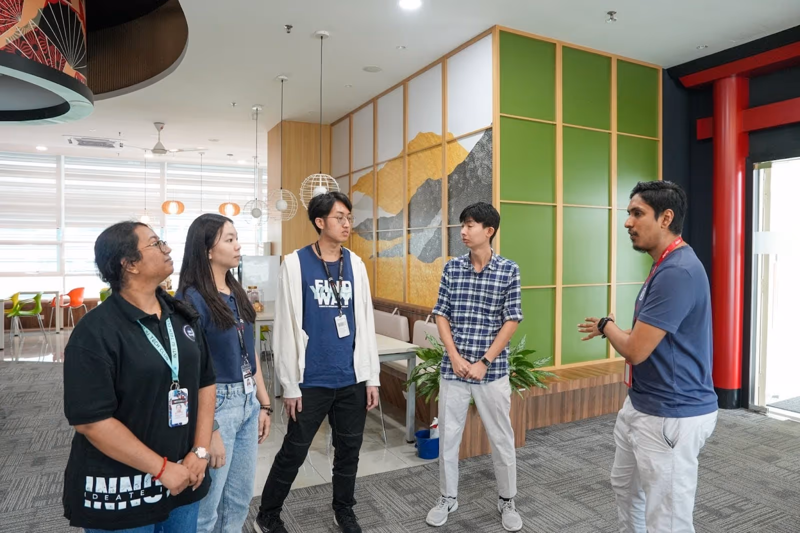 A Deriv team member giving an office tour to members of INTI’s IT Society.