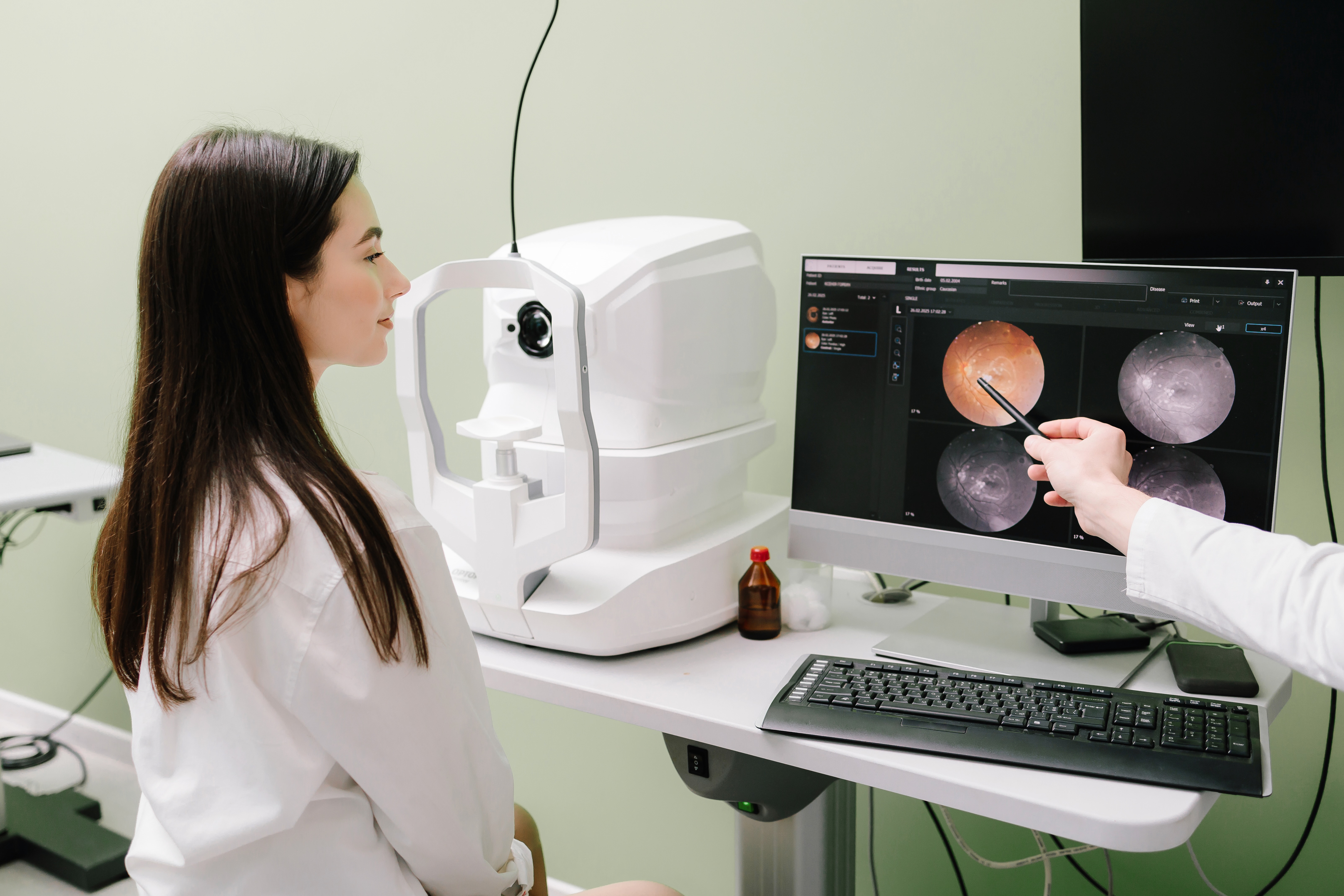 OCT eye scan Worcester opticians. Image shows young girl in white shirt being shown OCT images on a screen