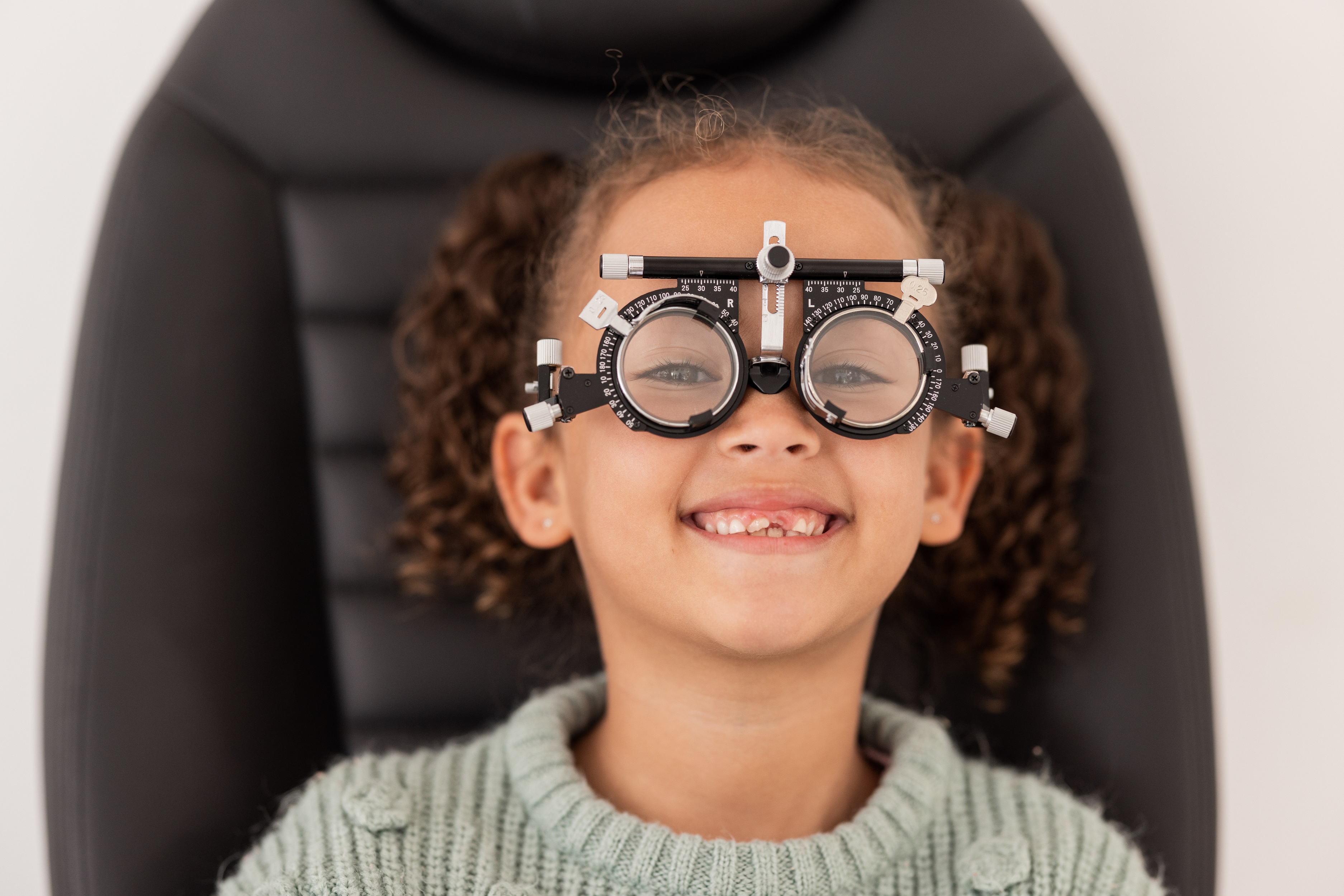 young girl sitting ready for eye test for myopia control