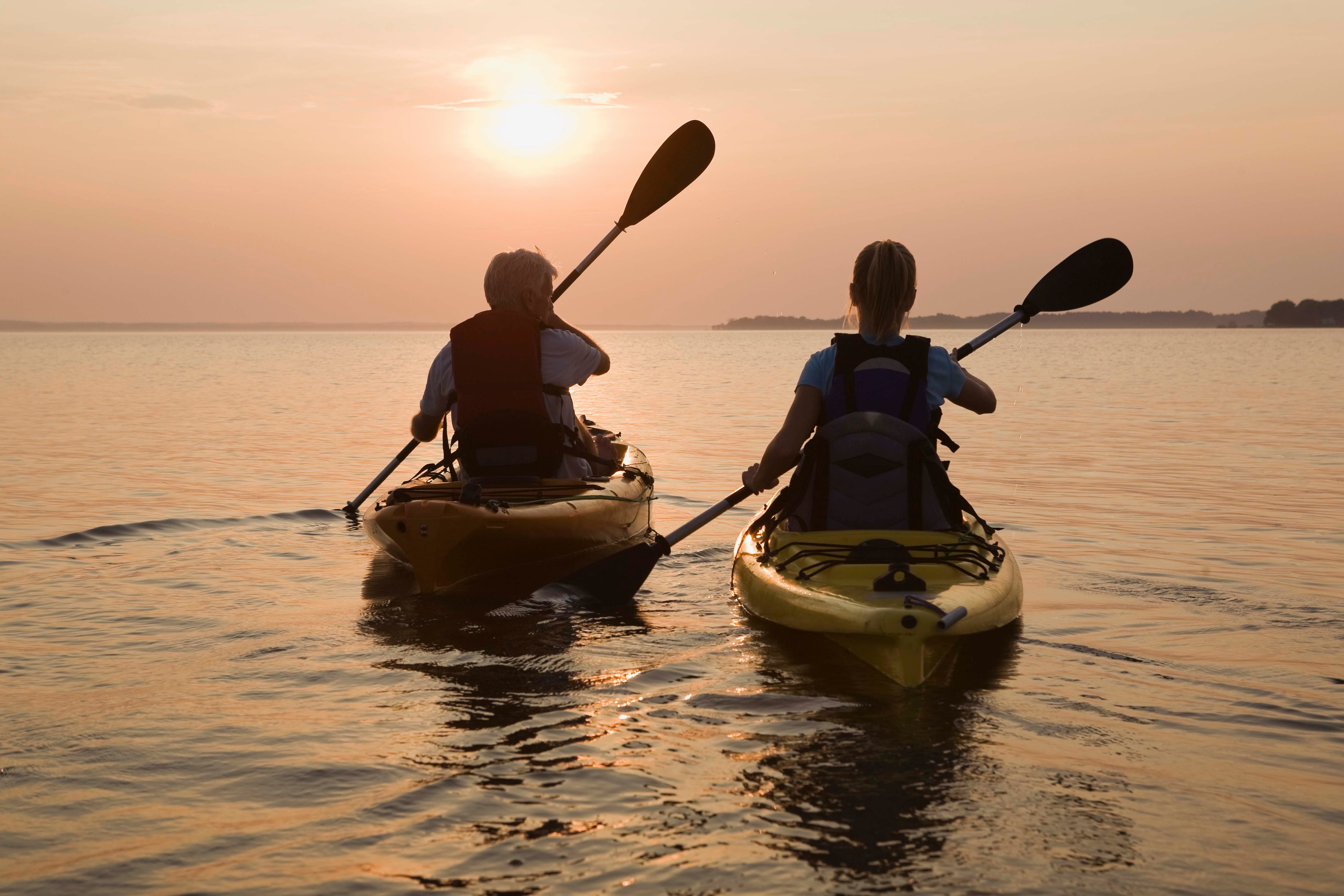 Two people kayaking on water together.