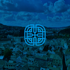 Logo of a stylized blue Jeep grille over a cityscape with rooftops and hills under a partly cloudy sky.