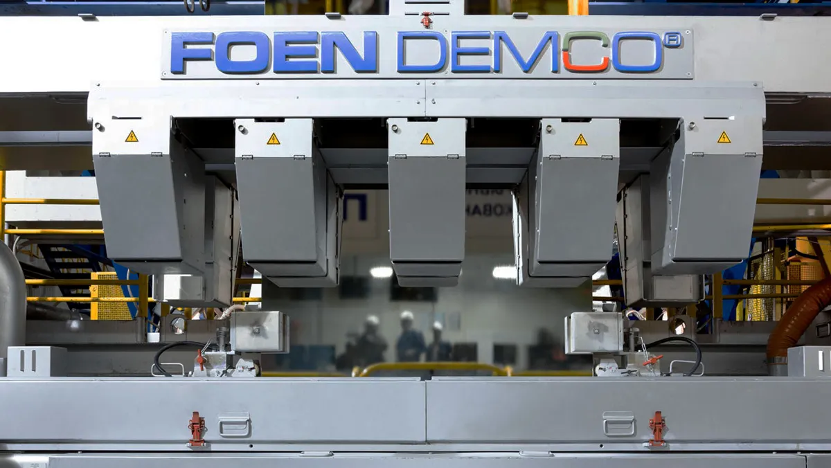 Industrial machine with the FOEN DEMCO logo in a production plant.