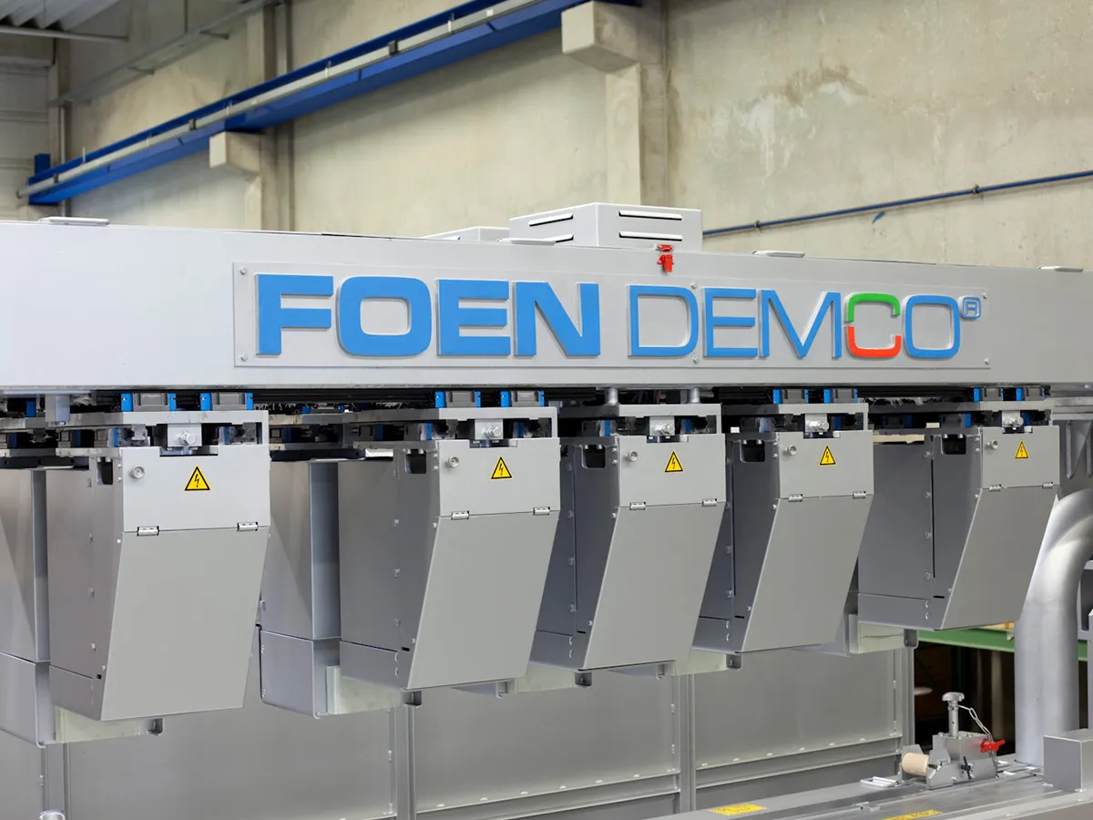Industrial machine with FOEN DEMCO inscription in a factory building.
