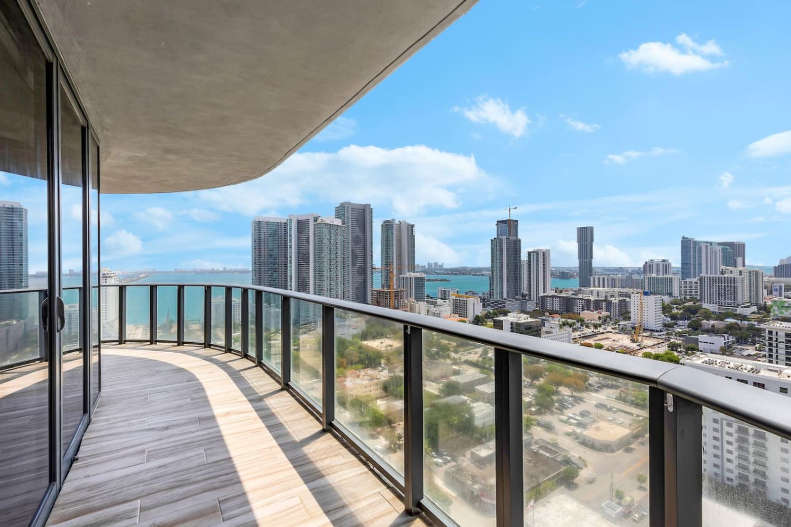 Curved high-floor balcony with views over the Miami skyline and Biscayne Bay