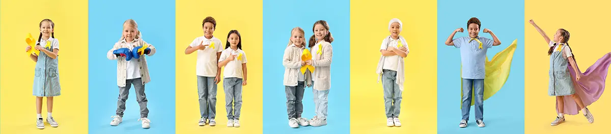 Seven children standing in pairs against alternating blue and yellow backgrounds, wearing yellow ribbons and playful clothing, with one child posed as a superhero with a cape.