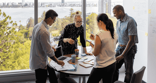 Team meeting four people standing
