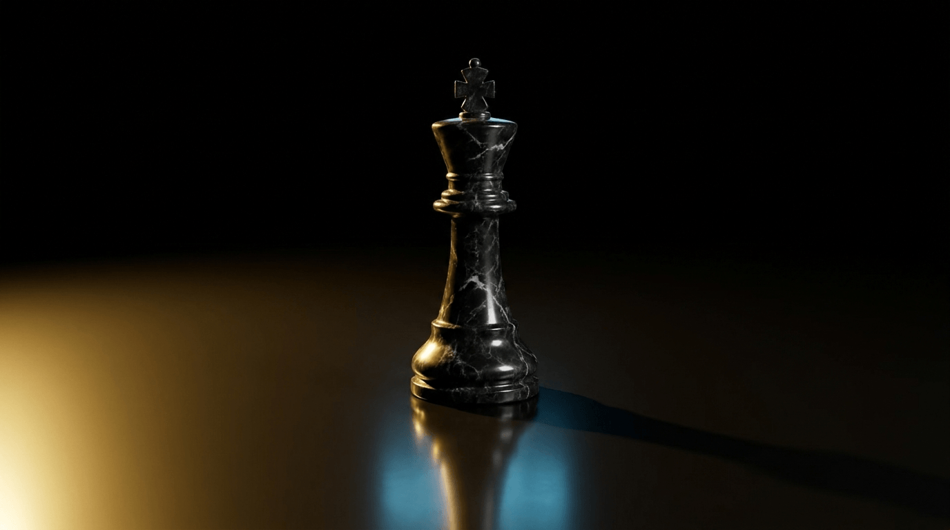 A single black marble king chess piece on a dark reflective surface, lit by warm gold and cool blue light.