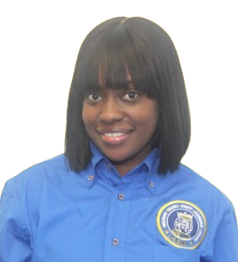 Ms. Bobb smiling in school uniform shirt with logo