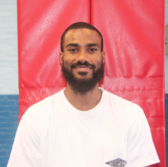 Mr. Heath smiling in the gymnasium