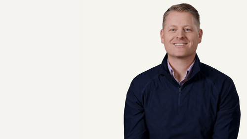 Woman with long brown hair beside KitchenAid logo, a Whirlpool company, product brand representative portrait.