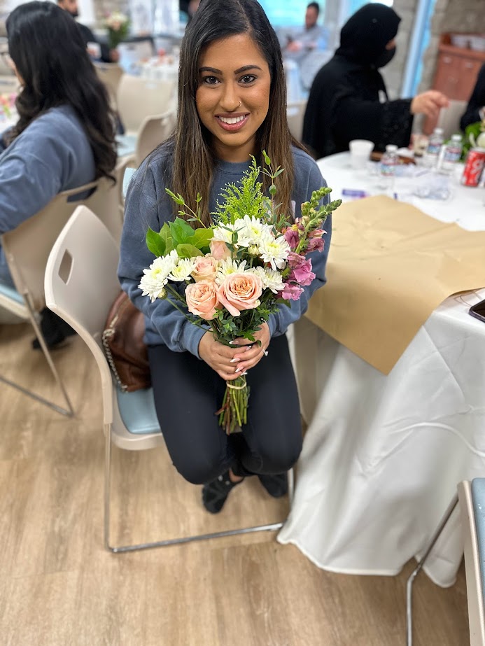 Woman holding flowers at a Light of Grief event in Orange County California
