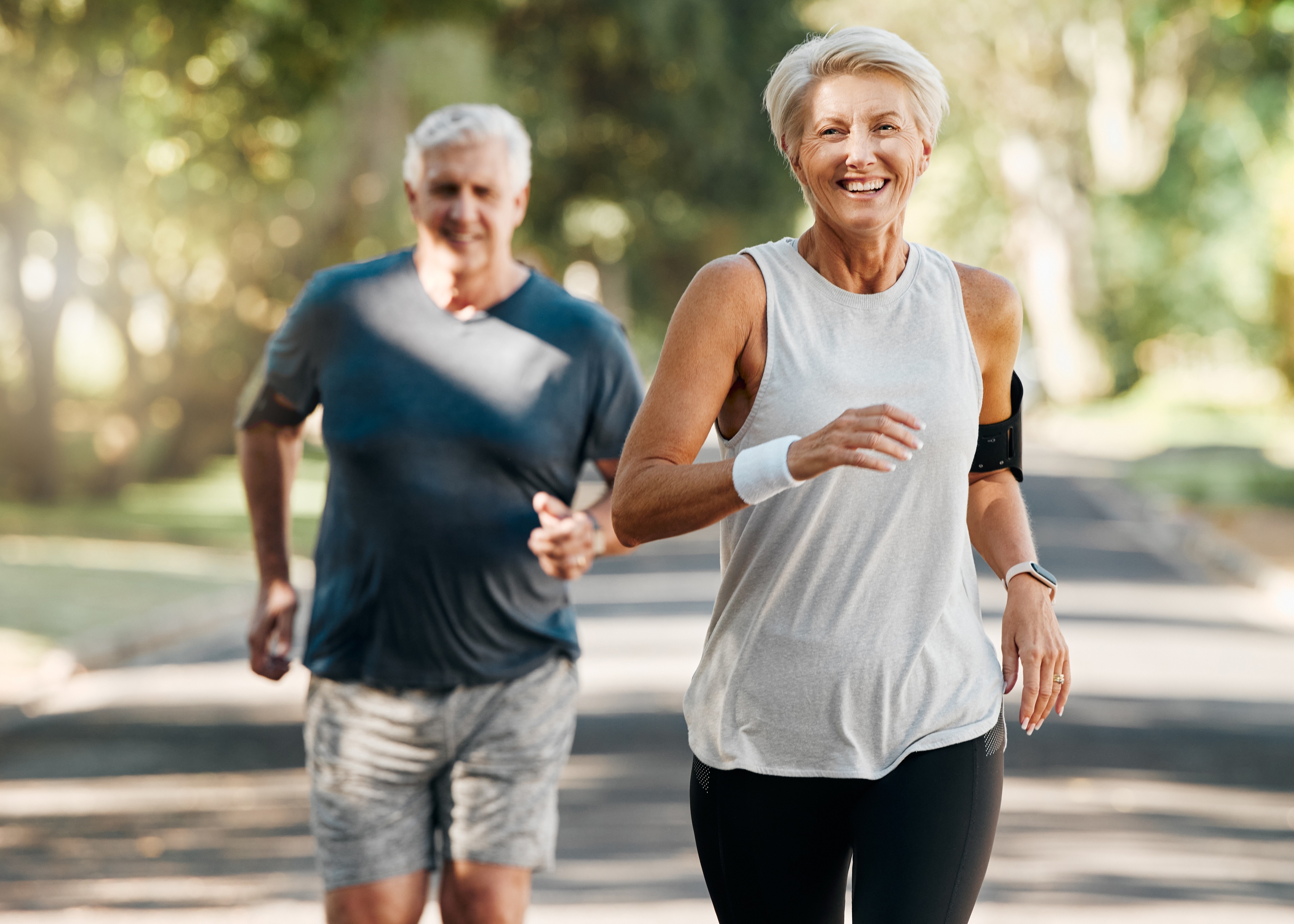 A man and a woman running down a street.