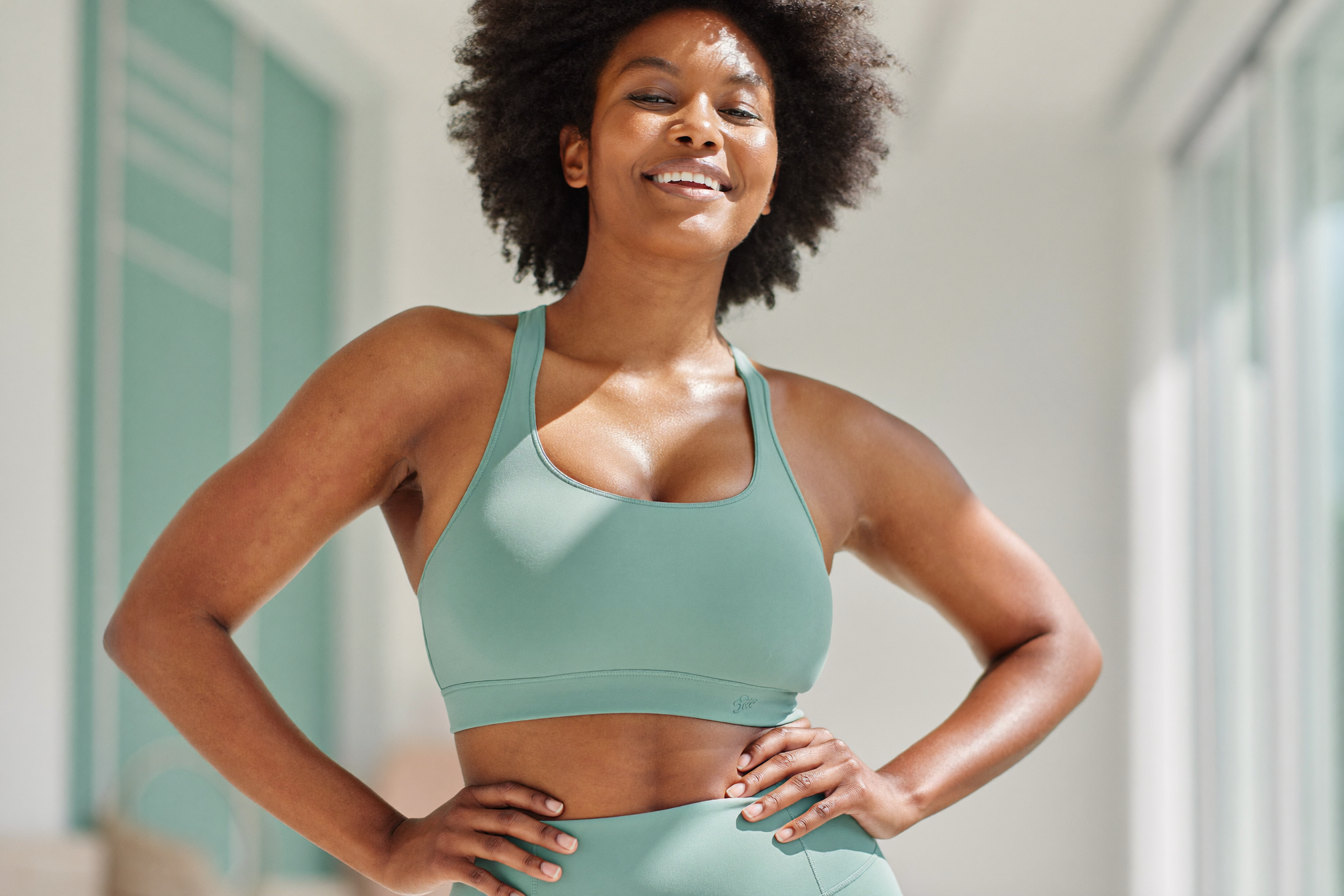 A strong, healthy woman in athletic wear representing muscle preservation and lasting results after GLP-1 weight loss in Wilmington, NC