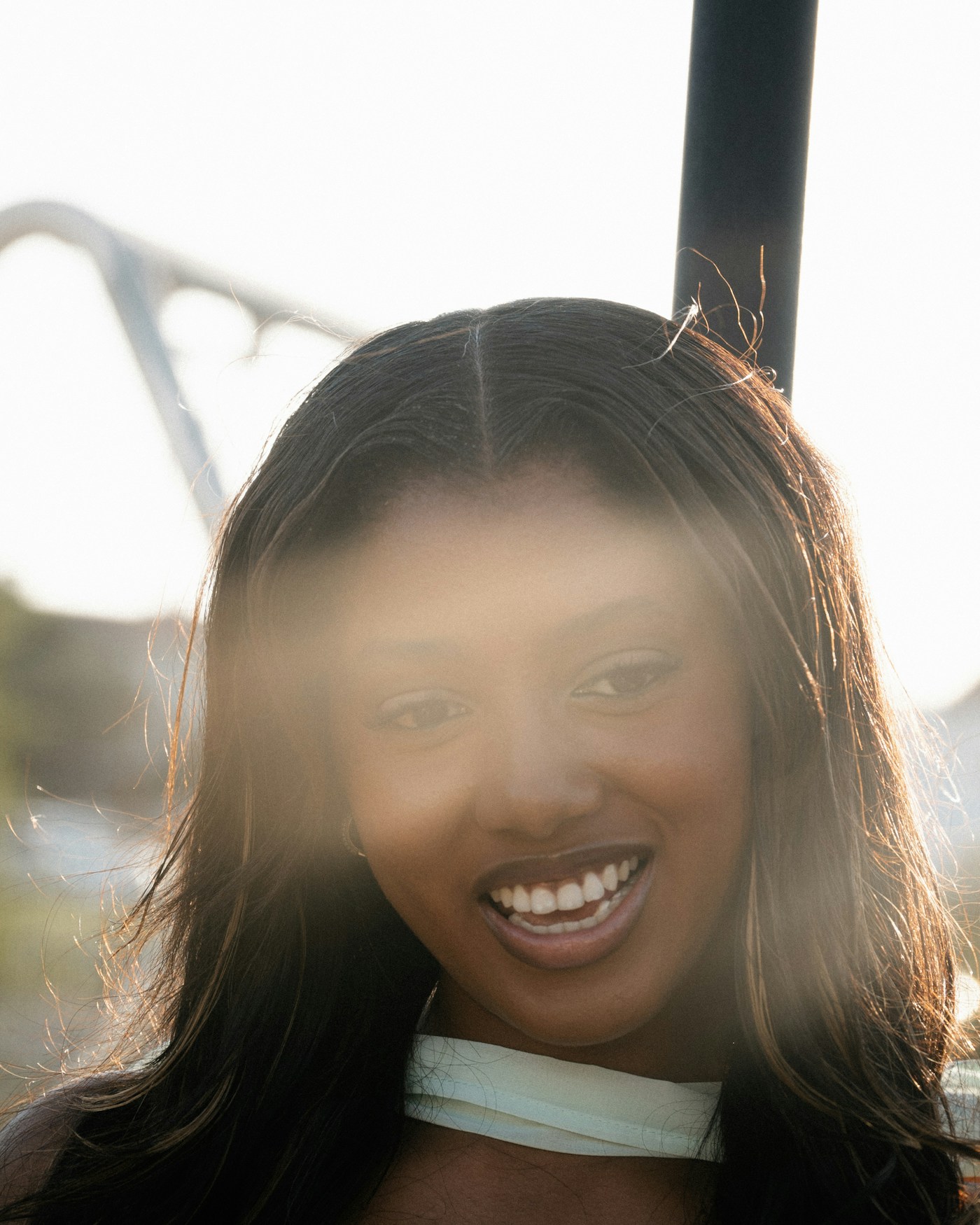 Woman with sunlight on her face and an open smile