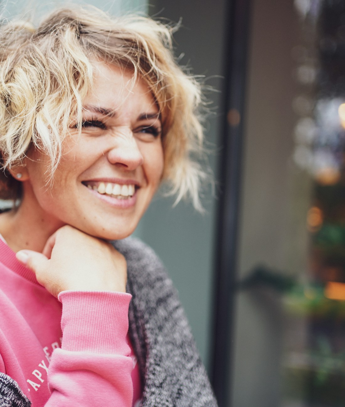 A woman smiling, looking relaxed and at ease