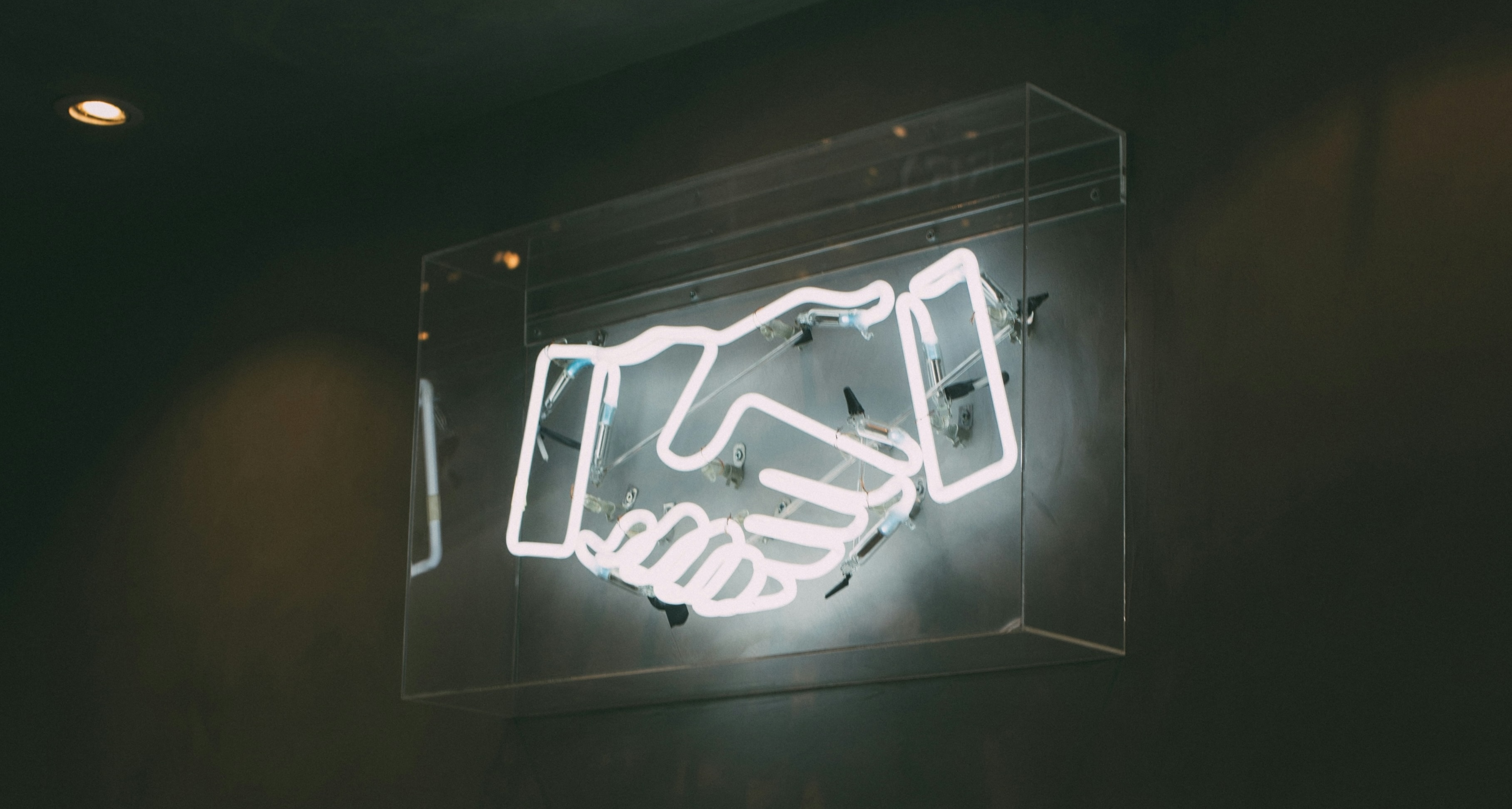 Neon sign of handshake