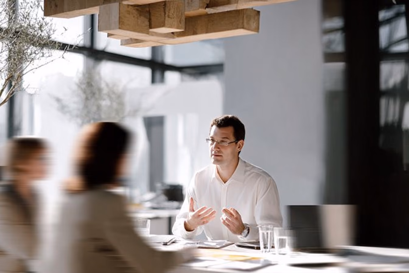 Two colleagues talking during a meeting