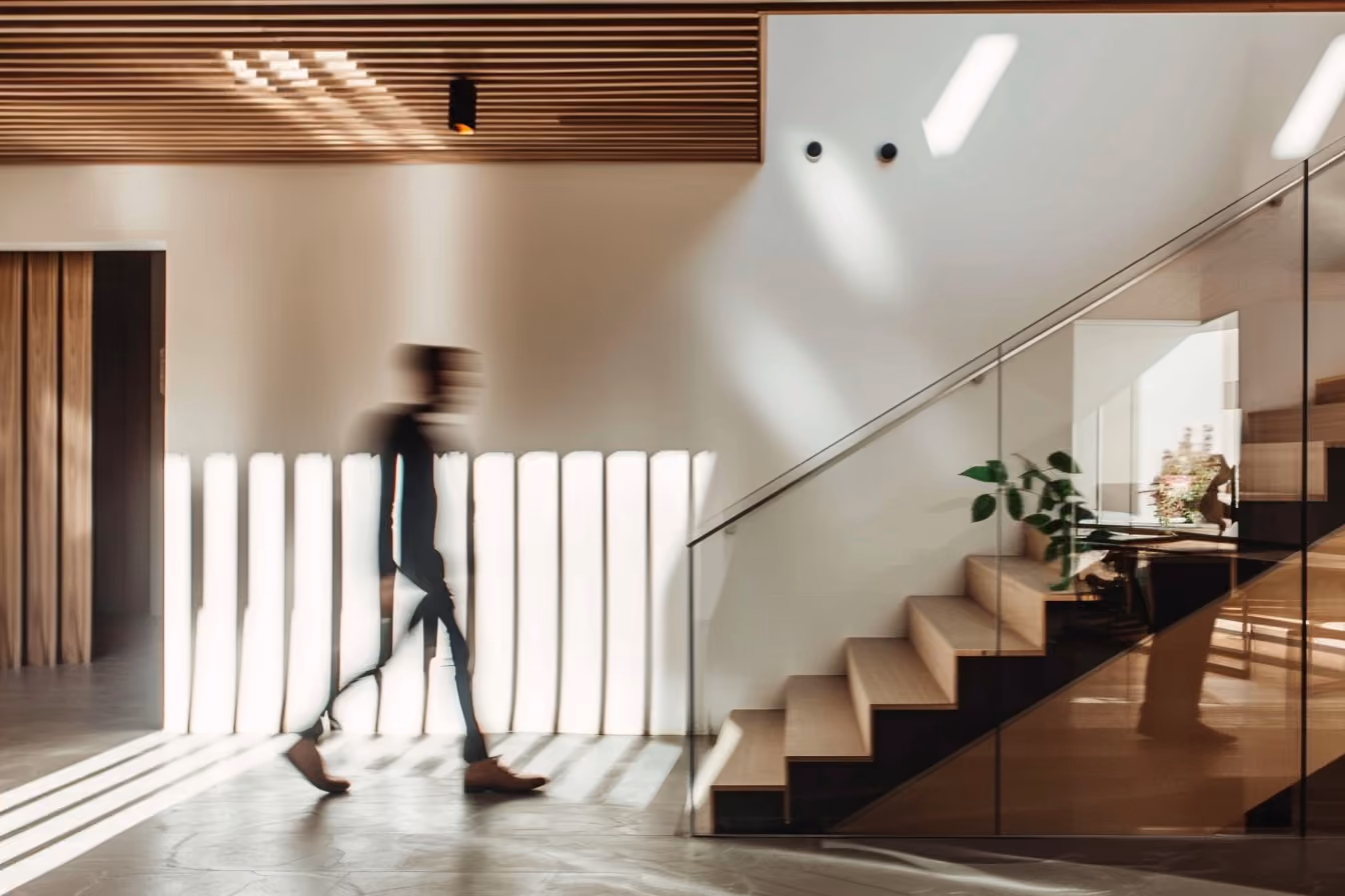 Person walking up wood staircase