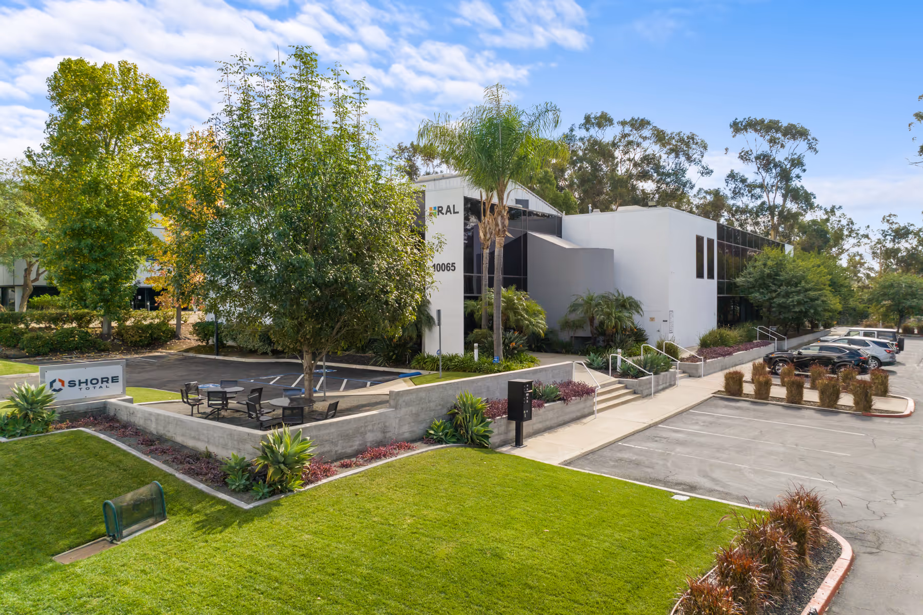 Modern office building with manicured landscaping and parking lot