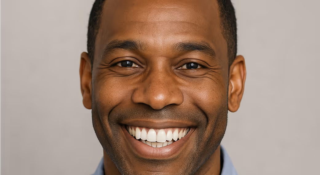 Close-up portrait of a smiling man showing off a bright, healthy set of teeth.
