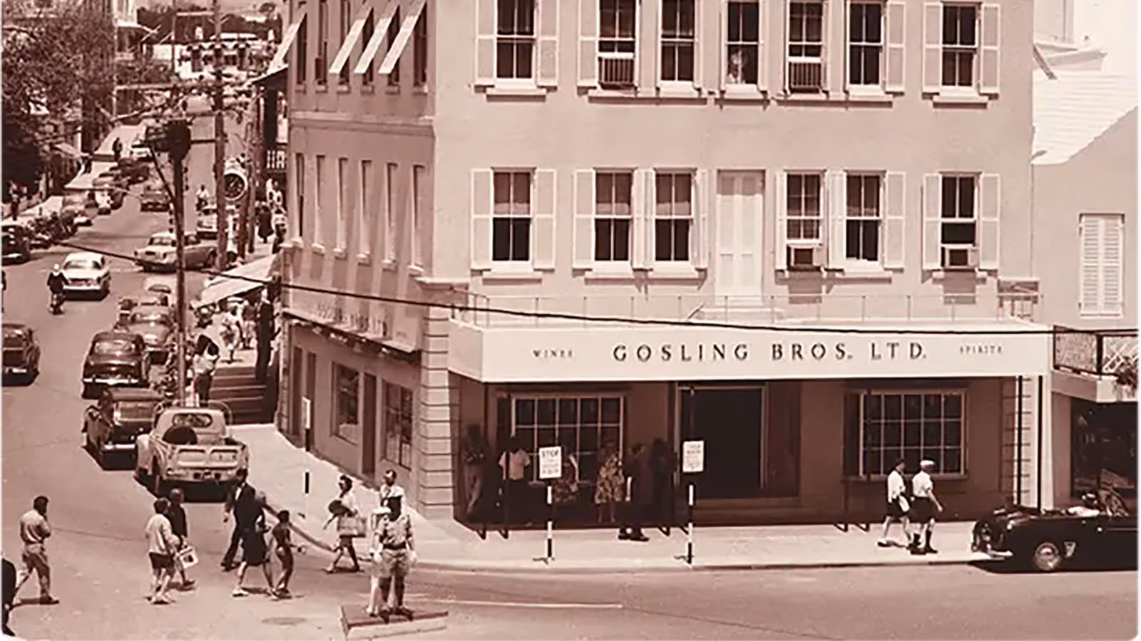 Vintage street scene with pedestrians and vehicles outside Gosling Bros Ltd. building.