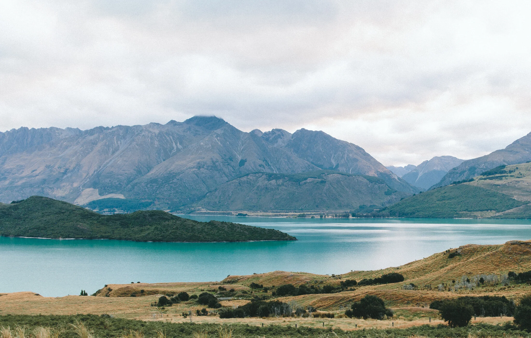 a lake with mountains in the background
