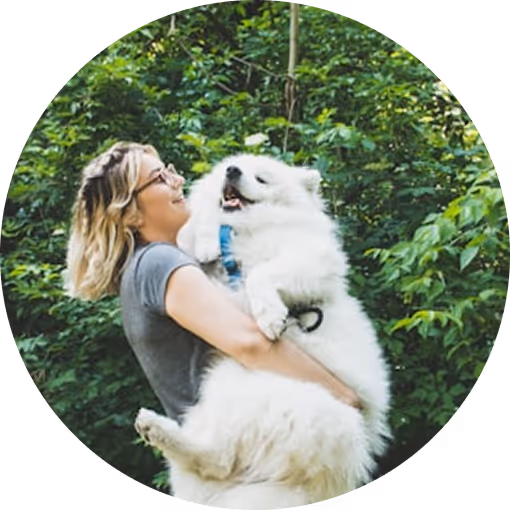 woman holding white dog