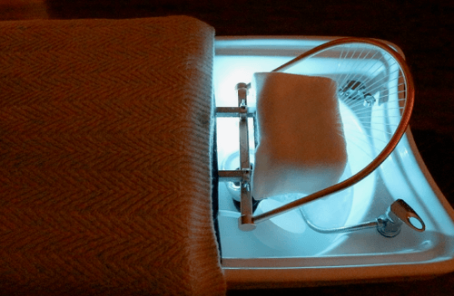 A head treatment table with colorful LED lights.