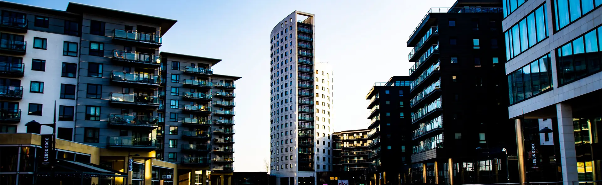 Slim modern tower framed by surrounding apartment blocks