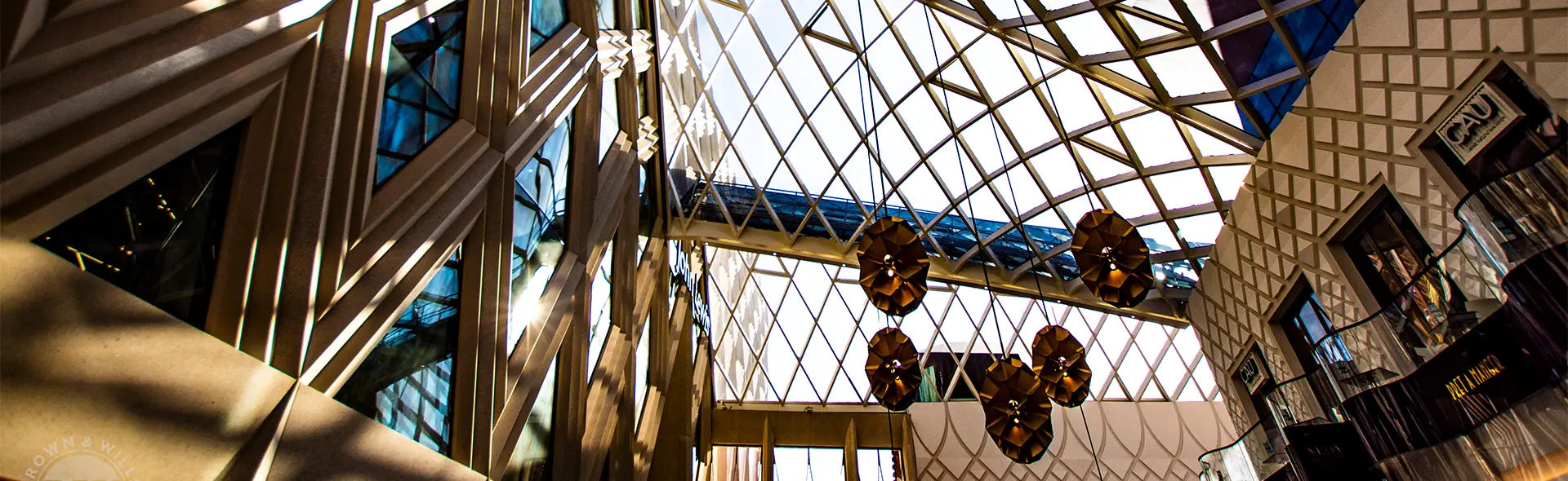 Atrium with diamond-pattern glass roof and hanging lights
