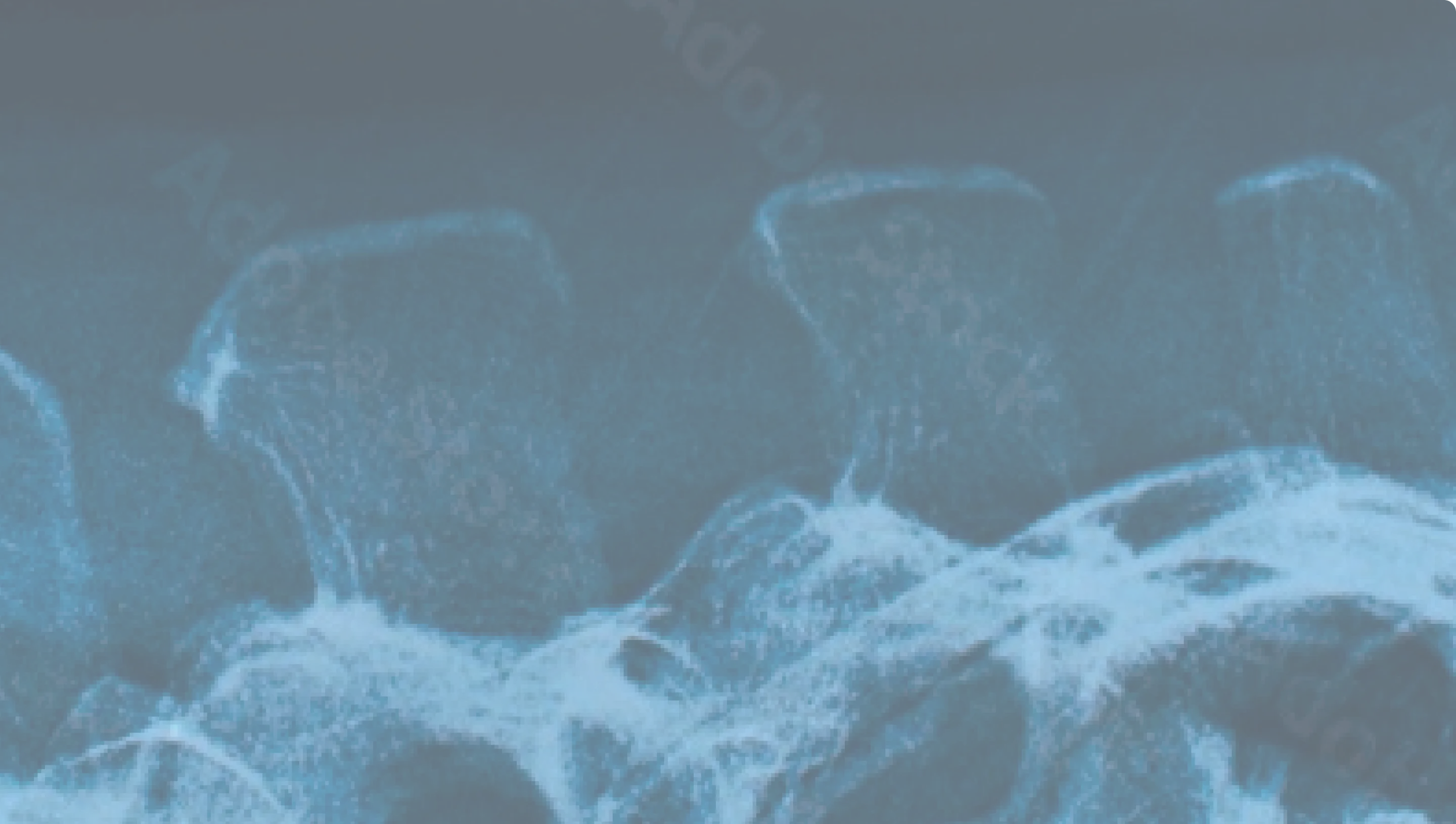 A close up of a cell phone with water in the background.