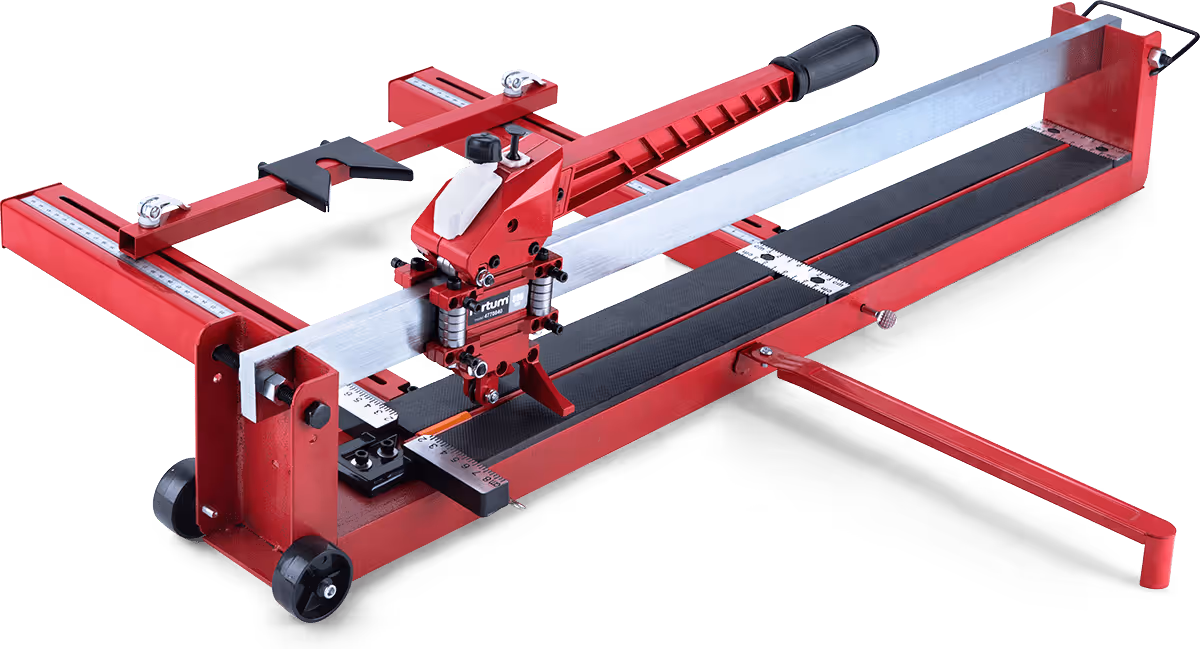 Red manual tile cutter with measuring scales, a long handle, and wheels for mobility.