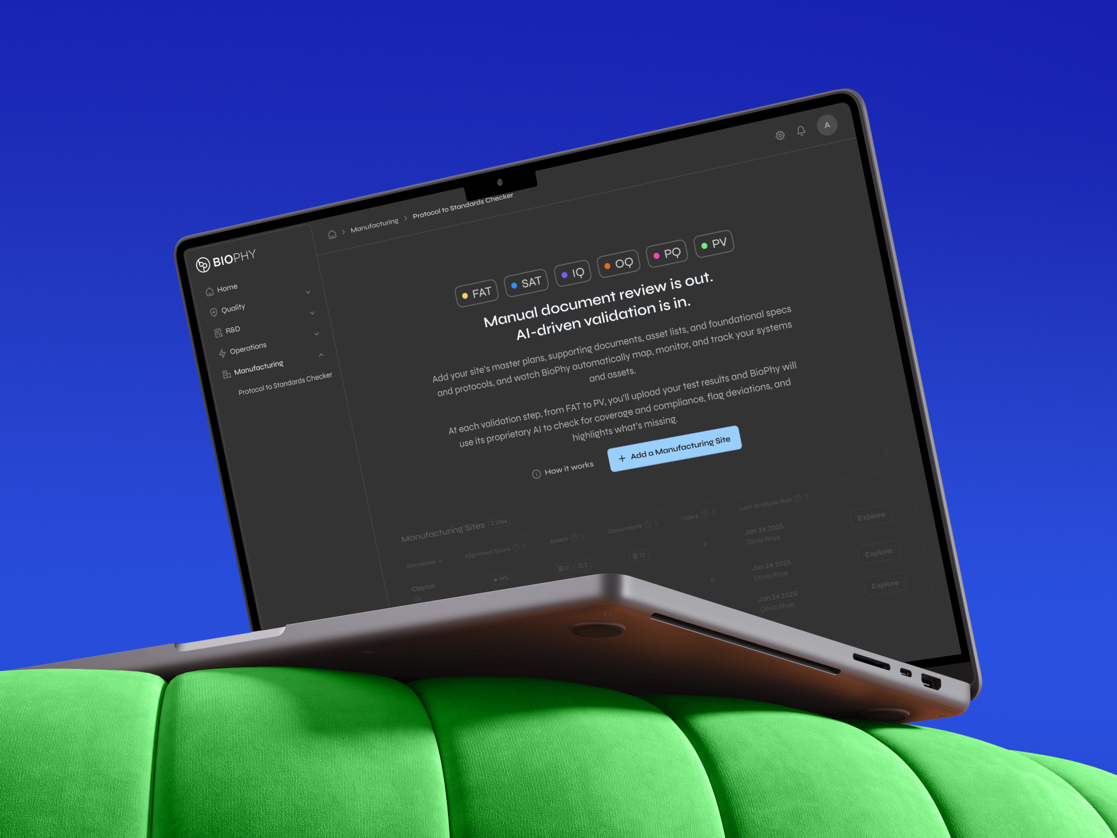 Laptop displaying BioPhy software interface for AI-driven manufacturing validation, placed on a bright green cushion against a blue background.