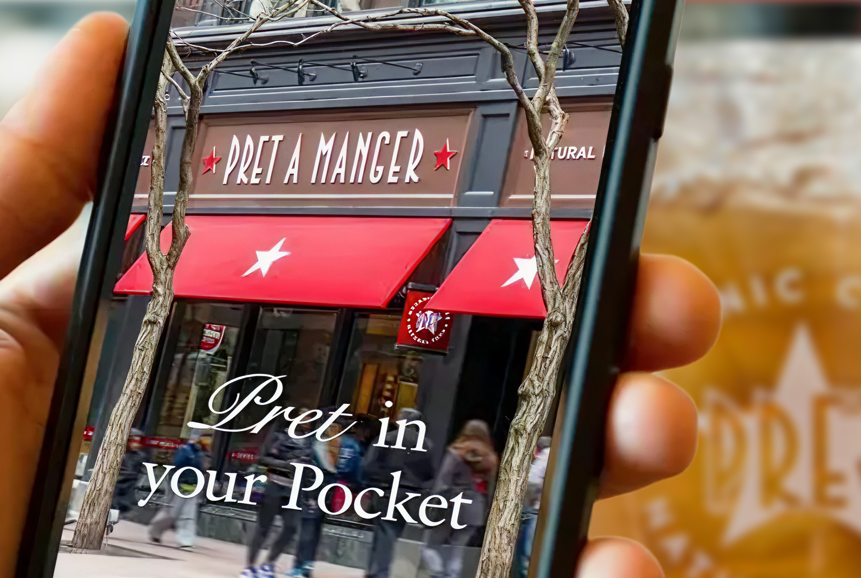 Close-up of a woman's face showing light skin with freckles, green eye, pink lips, a beige shirt, and a small earring.