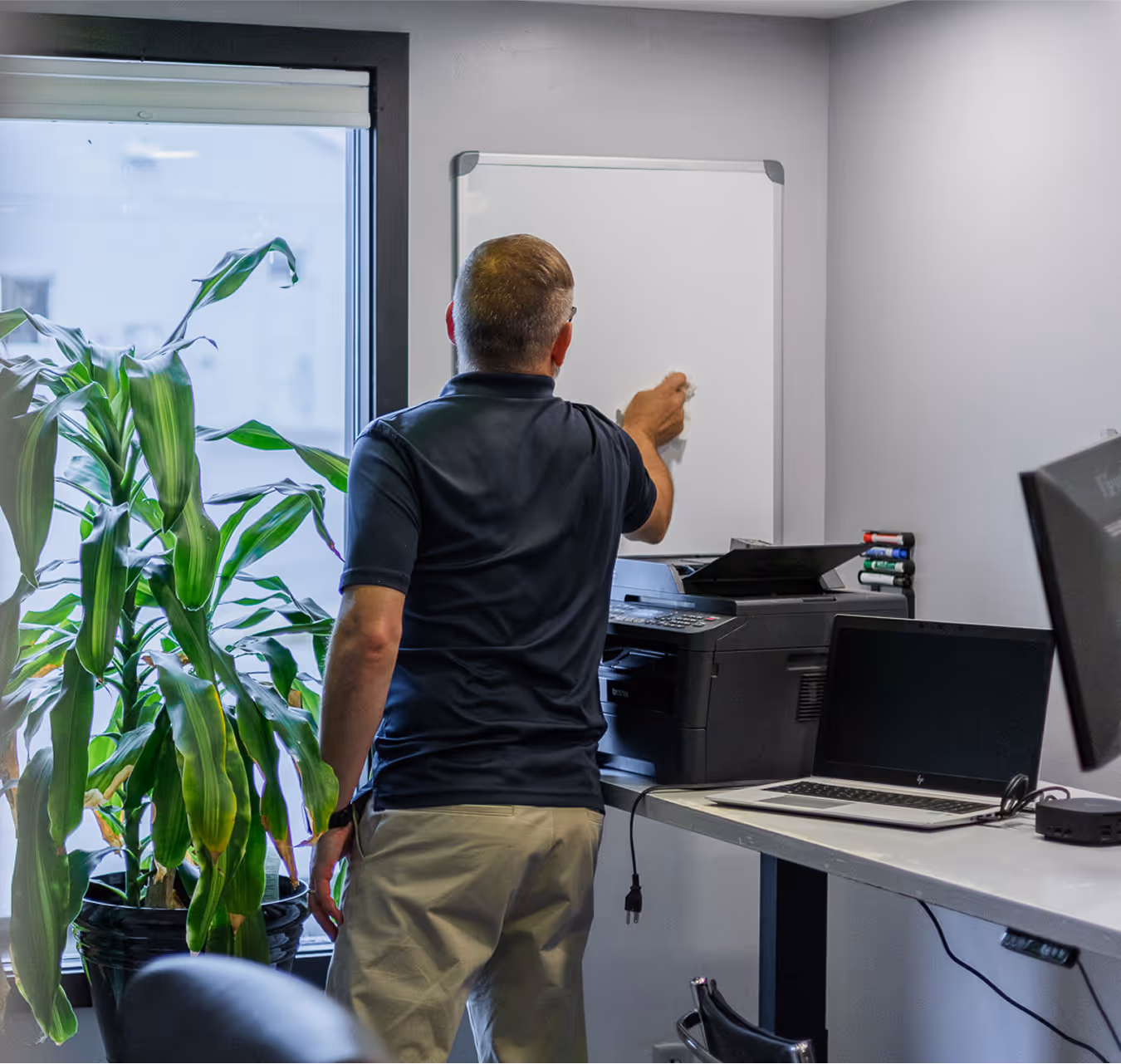 Owner Mike Davis wiping off a whiteboard in the office