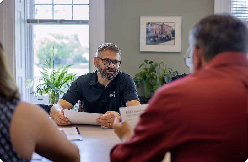 IT professional providing co-managed IT and cybersecurity support services in office meeting space.